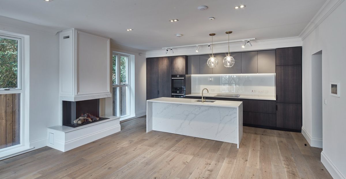 Open plan living space with feature fireplace at Dudlow Lane