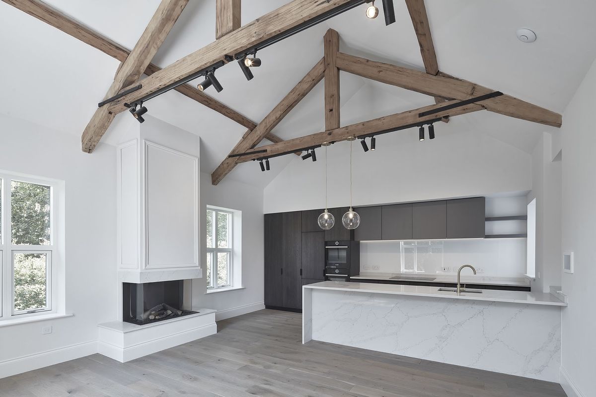Vaulted apartment interior with exposed timber trusses at Dudlow Lane