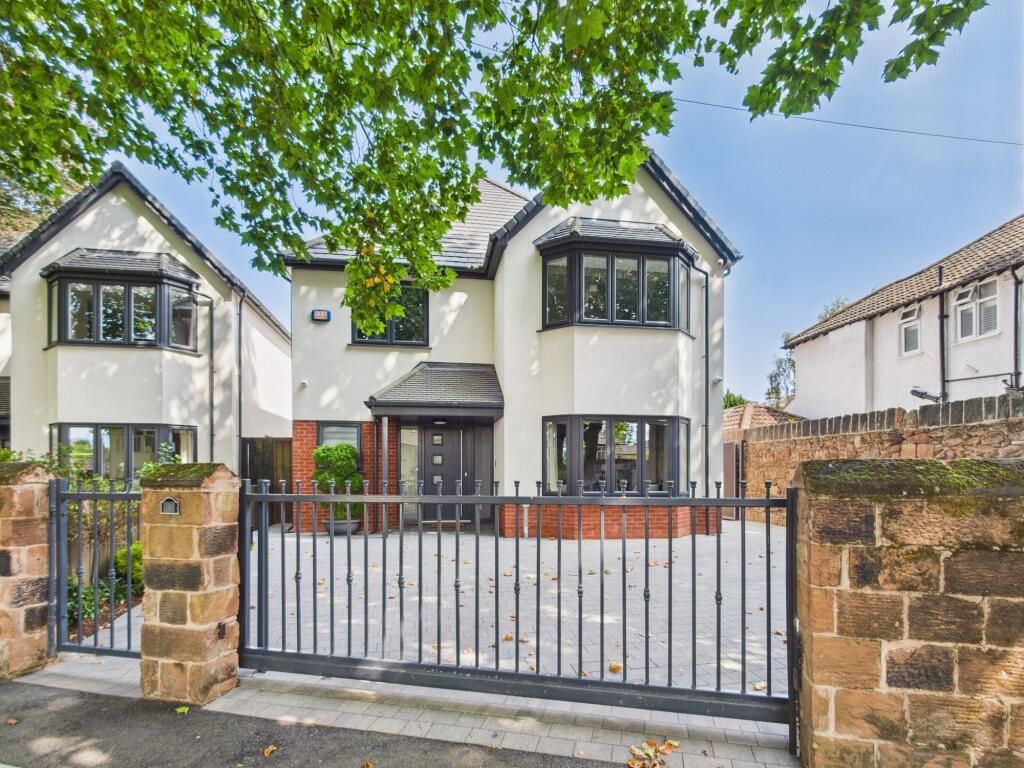 New build detached home at Dudlow Lane behind sandstone walls