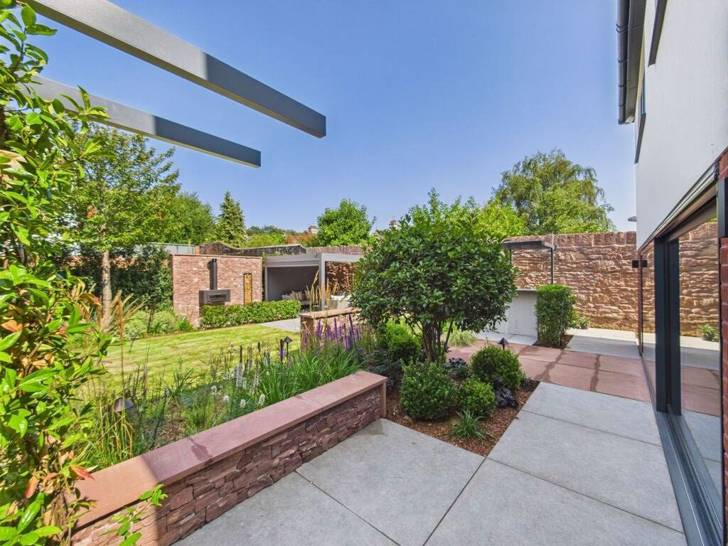 Landscaped garden with sandstone walls at Dudlow Lane